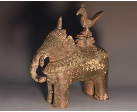 A 19th century Indian bronze censor or lamp, boldly cast as a processional elephant, his tasseled howdah surmounted by a hing