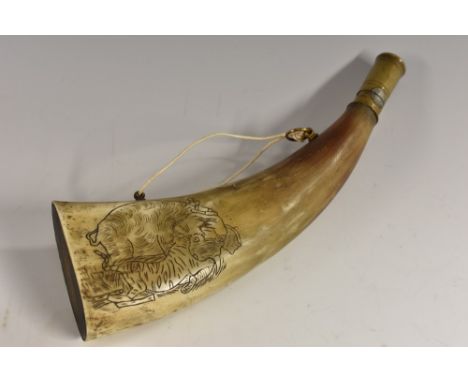 A 19th century Indian horn powder flask, 'scrimshaw' engraved with an elephant attacked by a tiger, 26cm wide