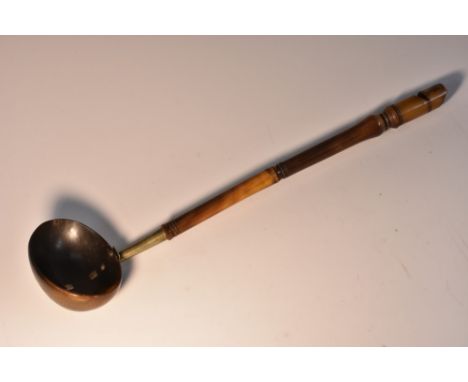 An 18th century Scottish cattle horn toddy ladle, oval bowl, turned handle with whistle terminal, 33cm long, c.1780