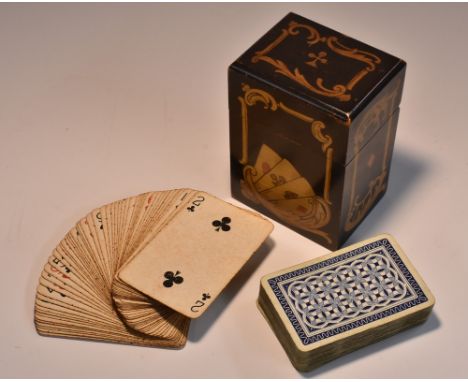 An Art Nouveau penwork rectangular playing card box, decorated with fanned aces and leafy scrolls, hinged cover enclosing twi