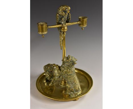 A large 19th century brass novelty animalier desk companion, the posted two-light candelabra surmounted by a perched parakeet