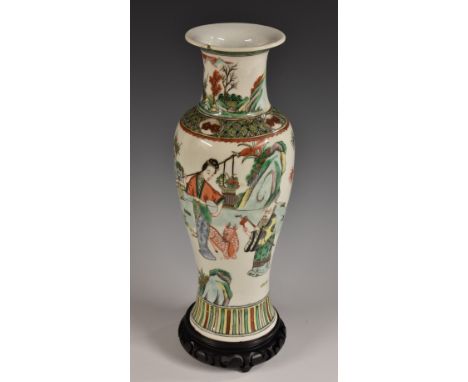 A Chinese slender ovoid vase, decorated in the famille verte palette with with figures and a deer in a garden, 30cm high, 19t