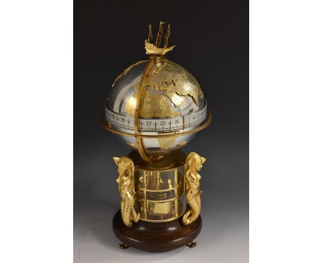 A 20th century commemorative annular clock, by St James House Co, London, the silver metal globe with applied gilt continents