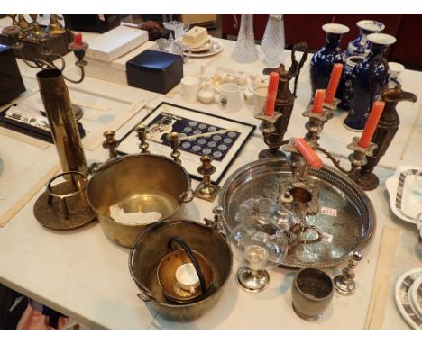 Quantity of silver plate and brass candlestick holders shell case and set of flight coins framed 