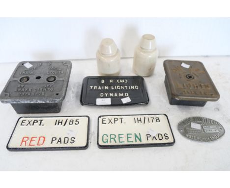 Two BR train light switches, a train lighting dynamo plaque, two wagon plaques, 'red pads' and 'green pads', a signal lever p