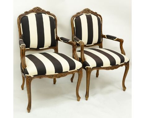 Pair of 20th Century Carved Wood and Upholstered Fauteuils. Light scratches to wood. Measures 40-1/2" H x 26" W. Shipping: Th