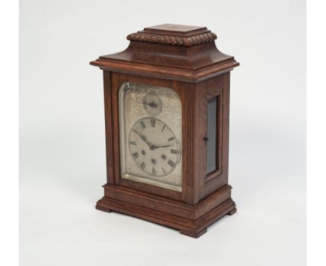 A CIRCA 1900 OAK CASED MANTEL CLOCK, the Gustav Becker three train chiming movement with a silvered dial, with pendulum and k