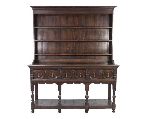 SEVENTEENTH CENTURY STYLE OAK DRESSER WITH PLATE RACK, the moulded cornice above a plain frieze and three shelves to the boar