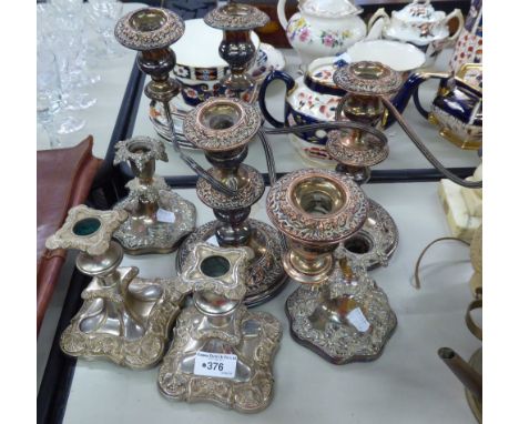 A PAIR OF SILVER ON COPPER THREE BRANCH CANDELABRA'S AND TWO PAIRS OF SILVER PLATE CANDLESTICK HOLDERS (6) 