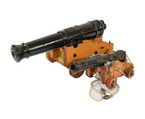 A Trafalgar Gun Club Model Cannon, the 37cm black painted cast iron barrel  with looped cascabel, cast with royal cypher, wit