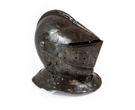 An Early 17th Century Composite Close Helmet, possibly Flemish, the two piece skull with folded and raised medial ridge, engr