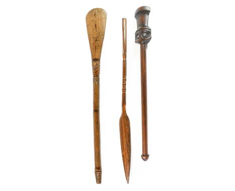 A Vanuatu Club, Melanesia, of dark brown wood, the rounded and waisted rectangular head with recessed "eye" sockets inset wit