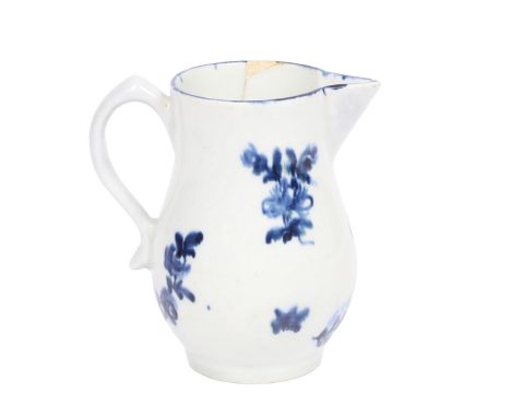 A LOWESTOFT BLUE AND WHITE PORCELAIN CREAM JUG, PROBABLY DECORATED BY THE "TULIP PAINTER", CIRCA 1772. The baluster body with