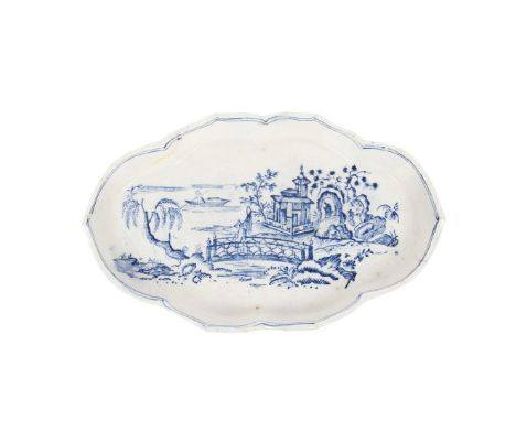 A RARE LOWESTOFT PORCELAIN SPOON TRAY. of oblong form, the central field decorated with a chinoiserie landscape scene with fi