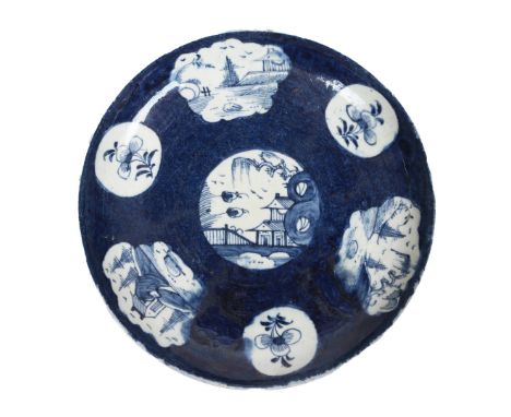 A LOWESTOFT PORCELAIN SAUCER DISH. with vignettes depicting landscape scenes and floral sprays, on a powder blue ground, 18cm