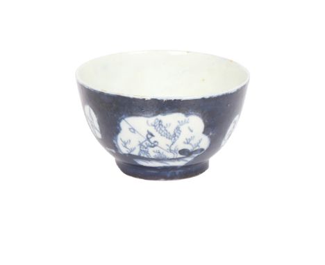 A LOWESTOFT PORCELAIN TEA BOWL. the powder blue ground with vignettes depicting a figure with fishing rod, a bird in flight a