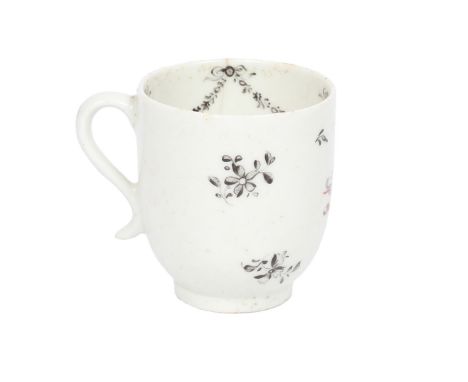 A LOWESTOFT PORCELAIN COFFEE CUP. with black floral spray decoration and central armorial crest for "Gough", the interior wit