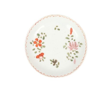 A VERY RARE LOWESTOFT PORCELAIN MINIATURE OR TOY SAUCER, CIRCA 1772. with polychrome floral spray decoration within a red arc