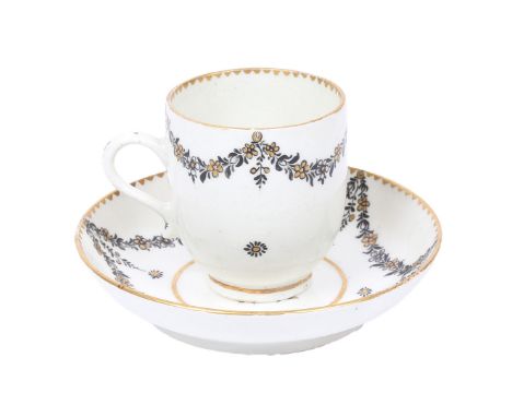 A LOWESTOFT PORCELAIN COFFEE CUP AND SAUCER. with black and gilt foliate swag decoration each piece bearing the armorial cres