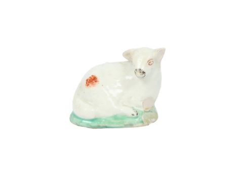 A LOWESTOFT PORCELAIN SHEEP. circa 1785-90, modelled on a green base with red highlights, 4.5cm wide, 3.5cm high  J. Howell c