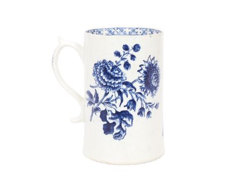 A LOWESTOFT PORCELAIN MUG. of tapering cylindrical form with scroll handle, the body transfer decorated with floral sprays an