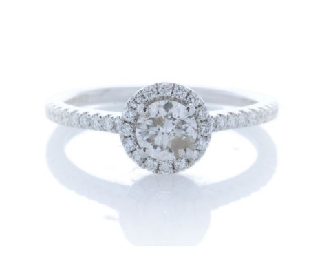 One natural round brilliant cut diamond 0.51 carats is surrounded by a sparkling halo of fourteen round brilliant cut diamond