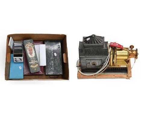 Archer &amp; Sons Magic Lantern with brass lens (fitted with electric lamp) together with a box of glass Magic Lantern Slides