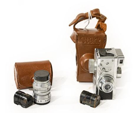 Steky Miniature Camera with Stekinar f3.5 25mm lens, an additional Steky-Tele f5.6 40mm lens, two film canisters and instruct