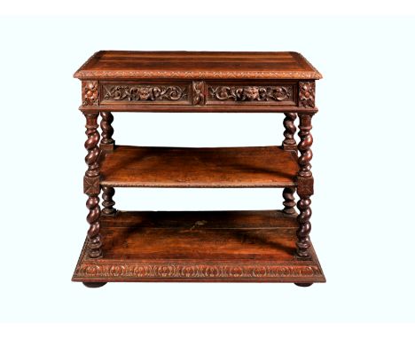 A Victorian carved oak three tier buffet, the top tier with carved egg and dart border over a pair of foliate carved drawers 