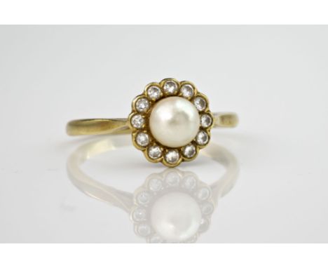 An 18ct yellow gold, cultured pearl and diamond cluster ring, the central pearl measuring approximately 6mm in diameter and s