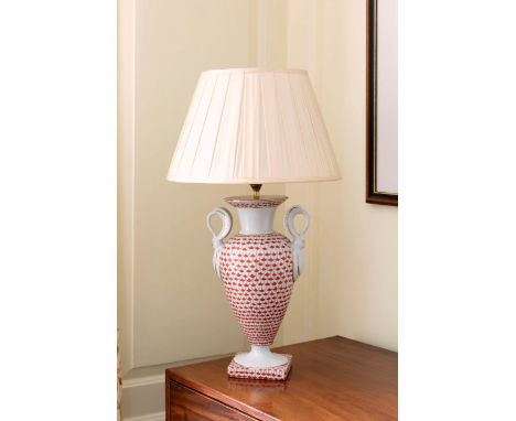 A Paris style porcelain vase lamp, late 20th century, with swan neck handles and pleated silk shade, 24¾in. (63cm.) high; tog