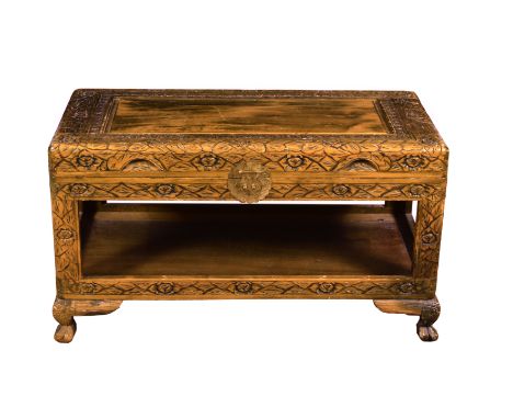 An Oriental carved wooden coffee table, 1950s-60s, of camphorwood chest style, the hinged, panelled top with floral and folia