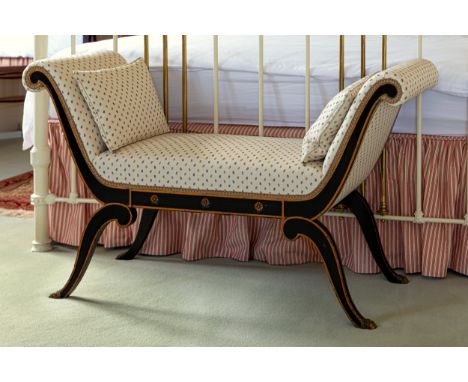 A Regency style window seat, first half 20th century, the scroll arms and seat upholstered in sprigged fabric, over an ebonis