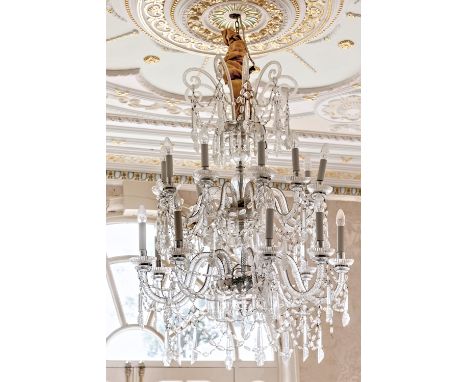 A Venetian style two tier eighteen light cut glass chandelier, first half 20th century, with spiral turned scroll arms with f