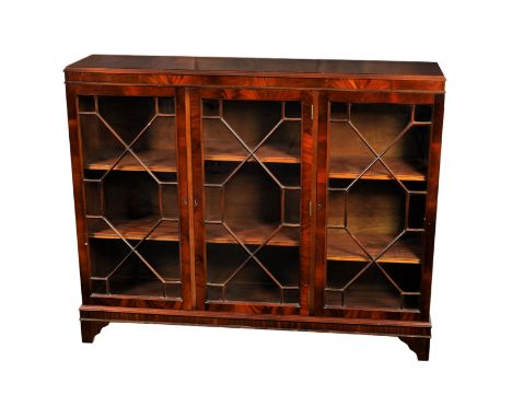 A Georgian style mahogany low glazed bookcase, the moulded top over three 13 pane astragal glazed doors, each section with tw