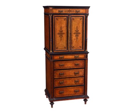 A late Victorian ebonised and burr amboyna cabinet in the manner of Edwards and Roberts, the ebony cross banded top over a si