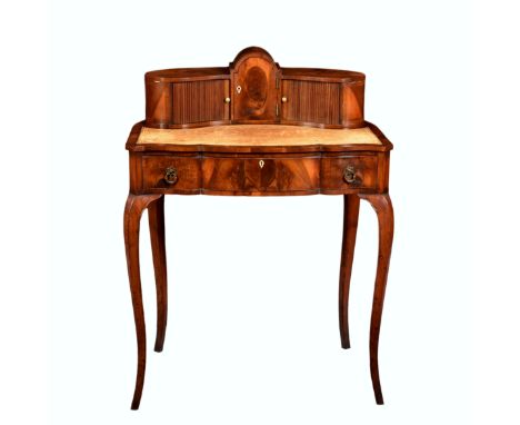 An 18th century style English yew wood bonheur du jour, first half 20th century, the bowfront superstructure with central arc