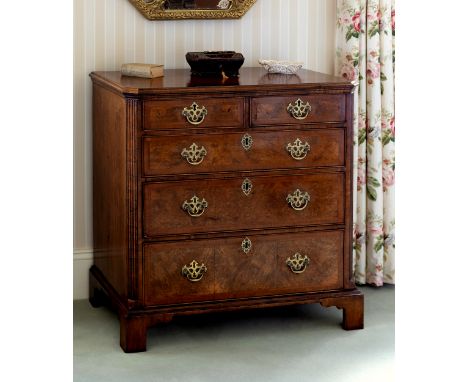 A Georgian walnut chest of drawers, probably originally the top of a chest on chest, adapted, the cross and feather banded to