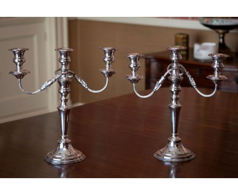 A pair of good quality twin branch silver plated table candelabra, with tapering knopped columns, the branches with reeded sc