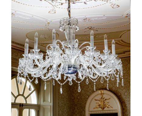 A large 19th century style sixteen light cut glass chandelier, second half 20th century, the scrolled arms with cut glass sco