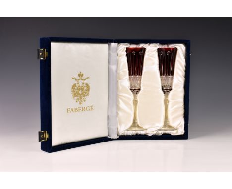 A boxed set of two Fabergé Xenia cut crystal ruby champagne flutes, late 20th century, the base inscribed 'FABERGE', 8 7/8in.