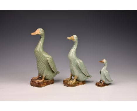 A graduated set of three Chinese celadon glazed porcelain figures of standing ducks, 20th century, one with impressed seal ma