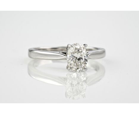 An 18ct white gold and oval cut diamond solitaire ring, the diamond weighing approximately 1.01ct and with GVS2 colouring. Ac