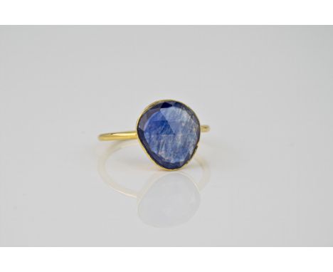 An 18ct yellow gold and sapphire ring, the central fancy cut sapphire held in a rubover setting on a slender yellow gold band