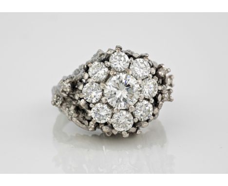 A vintage 18ct white gold and diamond cluster ring, the central brilliant cut diamond, approx. 1.00ct within a border of eigh