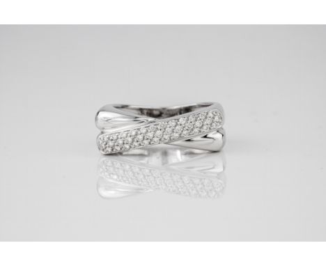 An 18ct white gold and diamond crossover ring, the polished band flattening into a square top, one of the crossover sections 