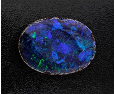 A loose, unmounted black opal doublet, oval, 36 x 21mm., with good kingfisher blue, dark blue, green and red colour.* There a