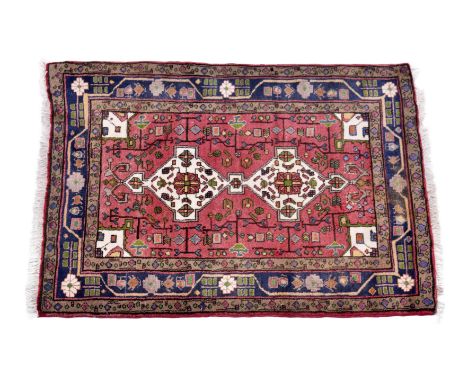 A small Kurdish Kolyai rug, second half 20th century, the two ivory geometric pendant medallions and conforming spandrels on 