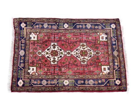 A small Kurdish Kolyai rug, second half 20th century, the two ivory geometric pendant medallions and conforming spandrels on 