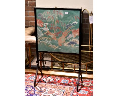 A Regency style ebonised fire screen, the screen lined with Liberty fabric depicting Oriental pheasants, 36¼in. (92cm.) high,